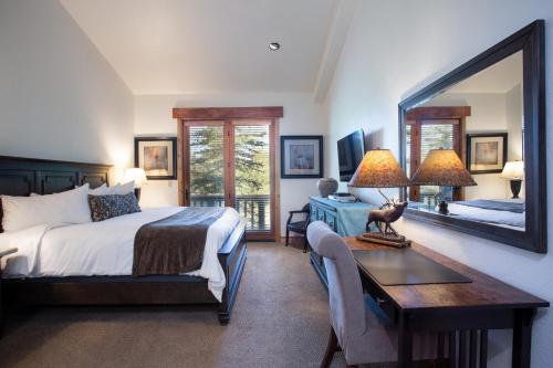 um quarto com uma cama, uma secretária e um espelho em Lodges at Deer Valley em Park City