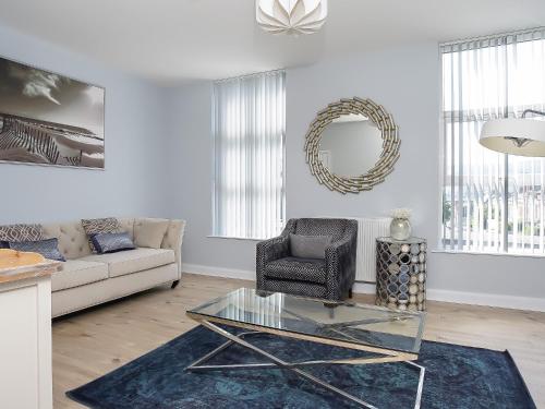 a living room with a glass table and a couch at City Centre 3 BDR Townhouse by Belfast City Breaks in Belfast