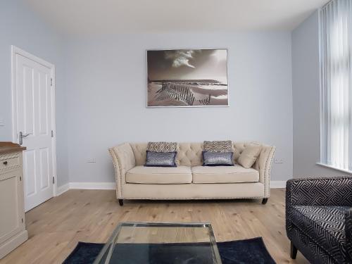 a living room with a couch and a glass table at City Centre 3 BDR Townhouse by Belfast City Breaks in Belfast