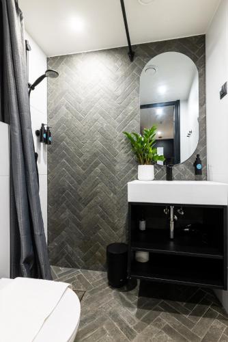 a bathroom with a sink and a mirror at Tempus Te Avangard Tallinn with terrace and gym in Tallinn