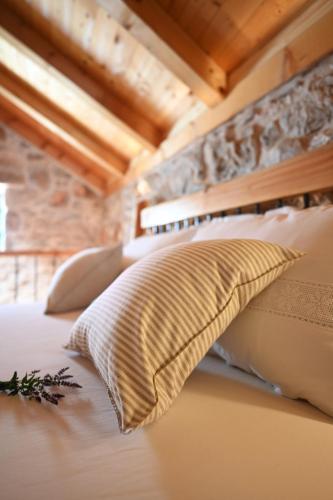 a bedroom with a bed with white pillows at Villa Teza Hvar in Hvar