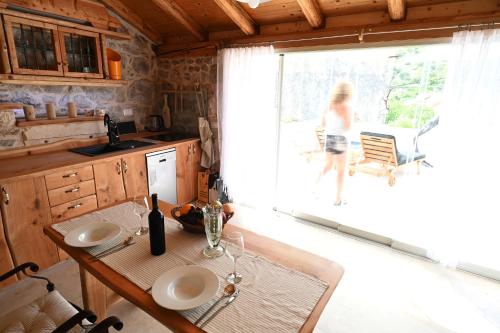 a woman walking out of the window of a kitchen at Villa Teza Hvar in Hvar