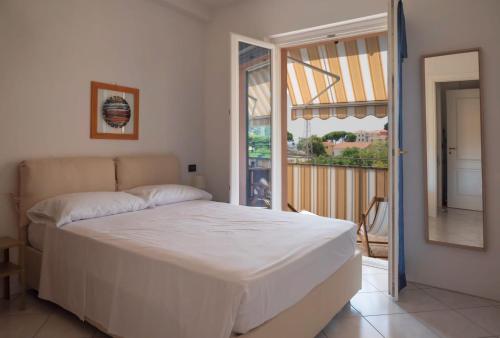 a bedroom with a bed and a balcony at Il Nido di Marta in Imperia