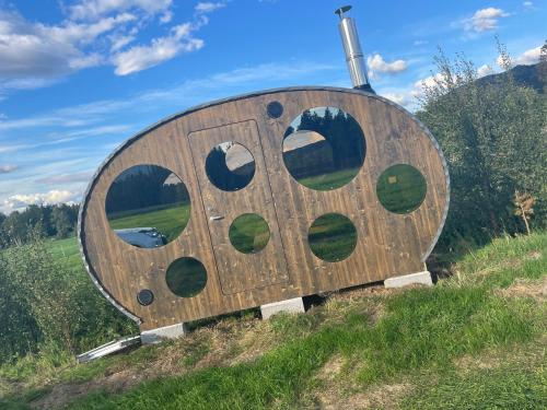 a large wooden structure on top of a hill at Flatmoen Natur Lodge in Alta