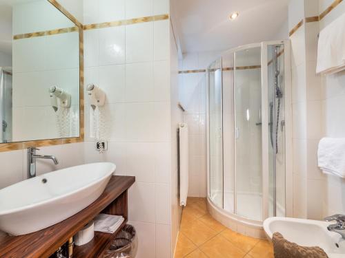 a bathroom with a sink and a shower at B&B MARINA contacless check in in Santa Cristina in Val Gardena