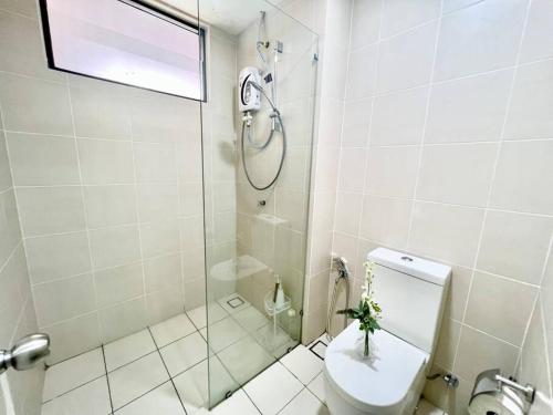 a bathroom with a shower and a toilet with a plant on it at G4 1-8pax Sunway Medical Center Geo 3QBeds Wifi &TV in Kampong Penaga
