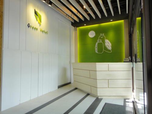 a gymnasium with a green sign on the wall at Green Hotel - Fengjia in Taichung