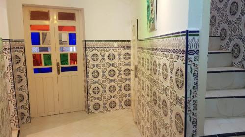 a room with doors and tiles on the walls at Alan's house Asilah in Asilah