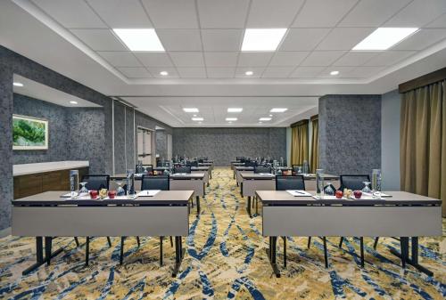 a rendering of a conference room with tables and chairs at Hilton Garden Inn Houston/Galleria Area in Houston