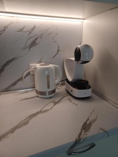 a coffee maker and a toaster sitting on a counter at Tara Deluxe Apartment in Varna City