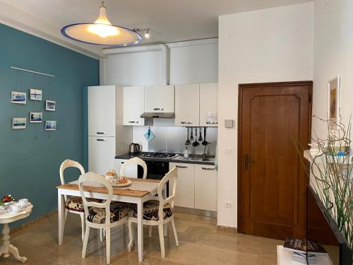 a kitchen with a table and chairs in a room at Quiet and comfort in the heart of Venice in Venice