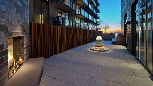a courtyard with a fireplace in a building at Canopy By Hilton Atlanta Midtown in Atlanta
