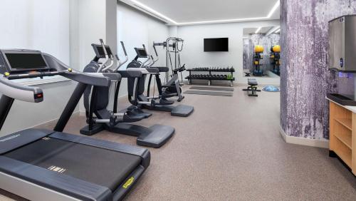 a gym with a row of treadms and cardio machines at Canopy By Hilton Atlanta Midtown in Atlanta