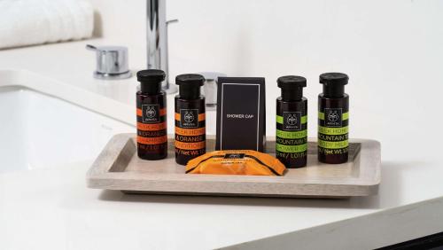 a shelf with four bottles of essential oils on a counter at Canopy By Hilton Atlanta Midtown in Atlanta