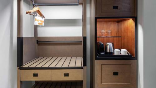 a walk in pantry with wooden cabinets and a cupboard at Canopy By Hilton Atlanta Midtown in Atlanta