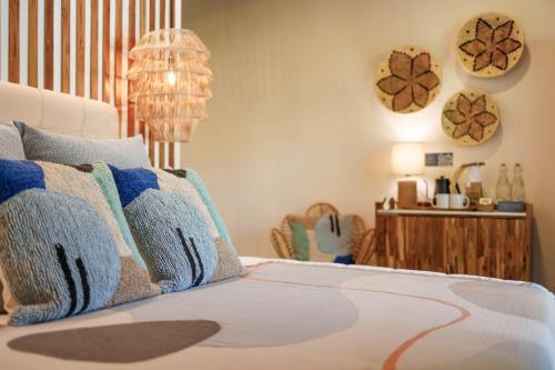 a bedroom with a bed with pillows on it at Exôtico Beach Hotel in Puerto Viejo