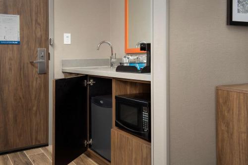 a kitchen with a sink and a microwave at Hampton Inn Baltimore-Downtown-Convention Center in Baltimore