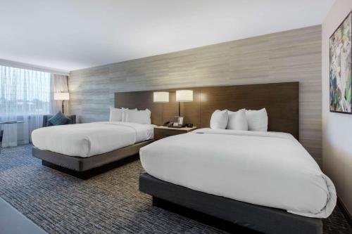 a large hotel room with two beds and a desk at DoubleTree Birmingham Perimeter Park in Birmingham