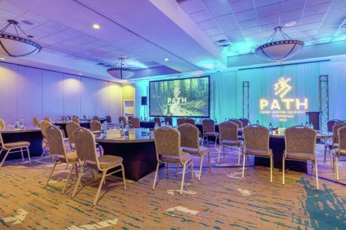 a conference room with a long table and chairs at DoubleTree Birmingham Perimeter Park in Birmingham