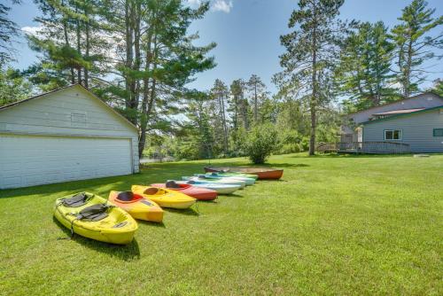 a row of kayaks lined up in a yard at Spacious Winter Retreat with River Access and Kayaks! in Winter