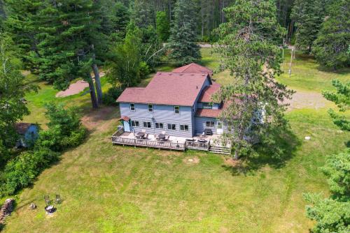 an aerial view of a house in a field at Spacious Winter Retreat with River Access and Kayaks! in Winter