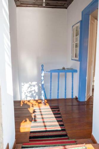 a room with a blue table and a rug on the floor at Nick and Avge's Stone House in Polichnítos