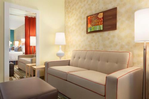 a living room with a couch in a hotel room at Home2 Suites By Hilton El Paso Airport in El Paso