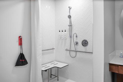 a white bathroom with a shower and a toilet at TownePlace Suites by Marriott Tampa Clearwater in Clearwater