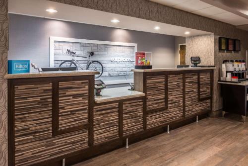 a bar in a restaurant with a bike on the wall at Hampton Inn Fort Lauderdale Plantation in Plantation