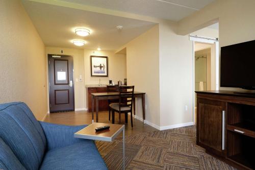 a living room with a couch and a dining room at Hampton Inn Green Bay Downtown in Green Bay