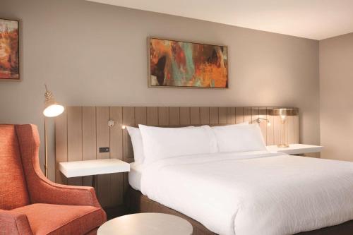 a hotel room with a bed and a chair at Hilton Garden Inn Phoenix-Tempe University Research Park, Az in Tempe
