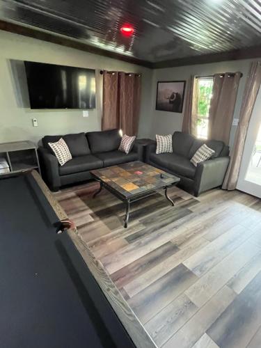 a living room with a couch and a table at Game Junction in Montgomery