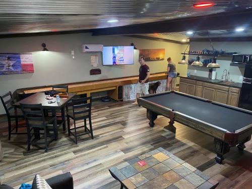two men standing in a bar with a pool table at Game Junction in Montgomery
