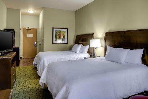 a hotel room with two beds and a flat screen tv at Hilton Garden Inn Pittsburgh/Cranberry in Cranberry Township