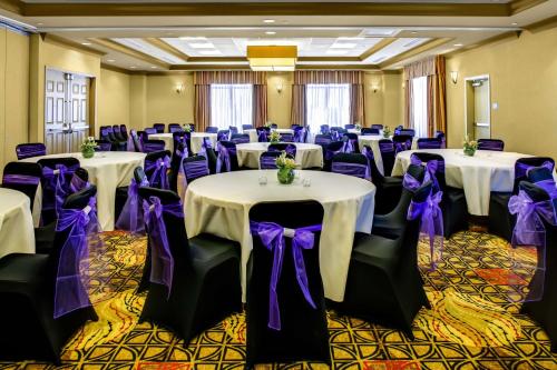 a room filled with tables and chairs with purple bows at Hilton Garden Inn Pittsburgh/Cranberry in Cranberry Township