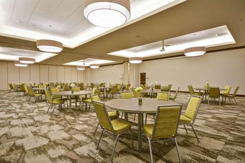 a large room with tables and chairs in it at Home2 Suites by Hilton Dallas Downtown at Baylor Scott & White in Dallas