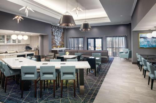 a restaurant with tables and chairs in a room at Homewood Suites by Hilton Atlanta Lenox Buckhead in Atlanta