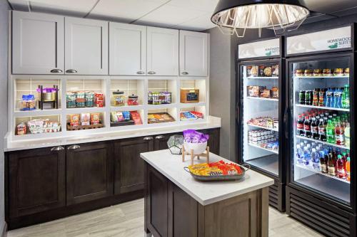 a kitchen with a refrigerator and a counter with food at Homewood Suites by Hilton Atlanta Lenox Buckhead in Atlanta