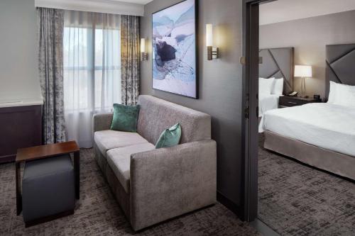 a hotel room with a couch and a bed at Homewood Suites by Hilton Atlanta - Buckhead in Atlanta