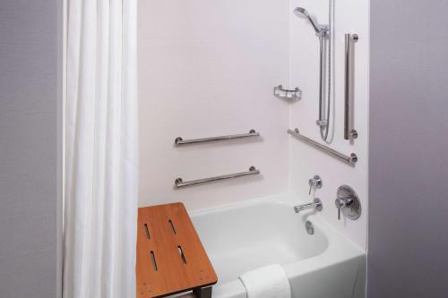 a bathroom with a bath tub and a wooden table at Homewood Suites by Hilton Atlanta Lenox Buckhead in Atlanta