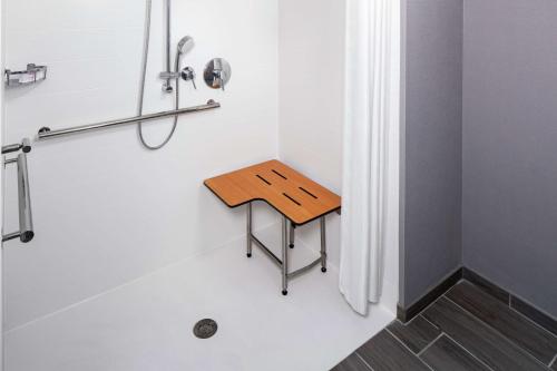 a small wooden stool in a bathroom with a shower at Homewood Suites by Hilton Atlanta - Buckhead in Atlanta