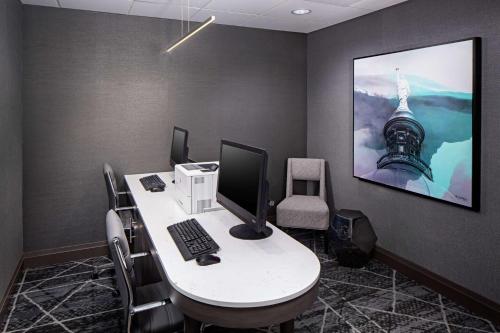 an office cubicle with a desk with a computer on it at Homewood Suites by Hilton Atlanta Lenox Buckhead in Atlanta