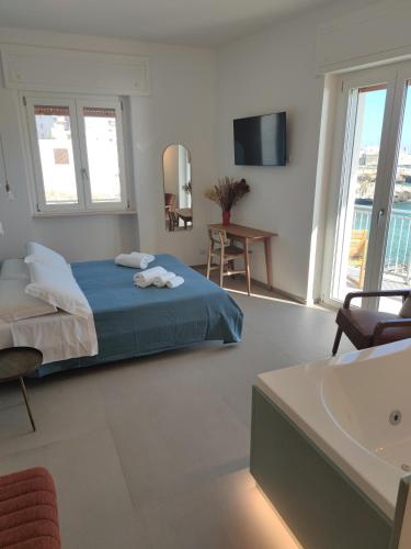 a bedroom with a blue bed and a sink at Sfumature D'aMare in Monopoli