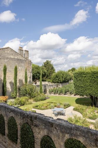 a view of a garden with a stone bridge at Hotel Porte Brunet in Saint-Émilion