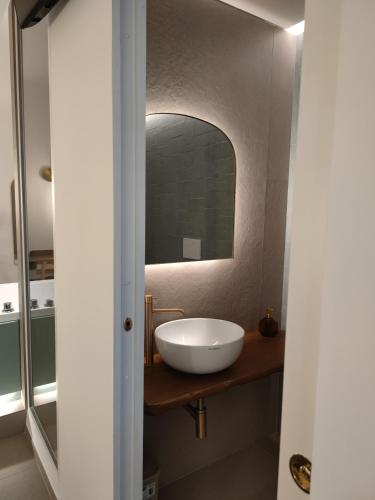 a bathroom with a sink and a mirror at Sfumature D'aMare in Monopoli