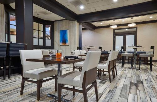 a dining room with a table and chairs at Hilton Knoxville in Knoxville