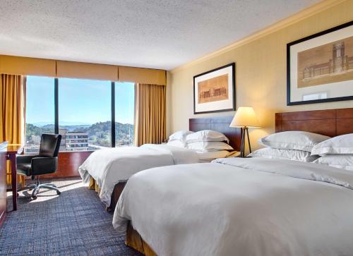 a hotel room with two beds and a window at Hilton Knoxville in Knoxville