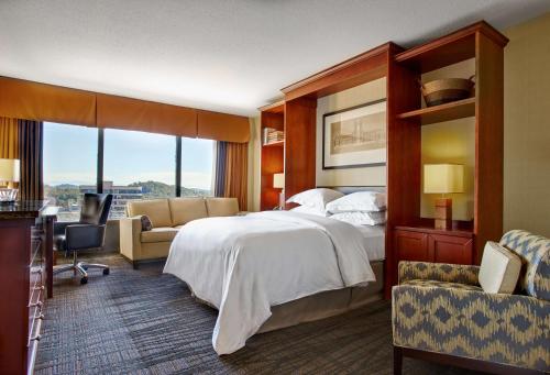 a hotel room with a large bed and a window at Hilton Knoxville in Knoxville