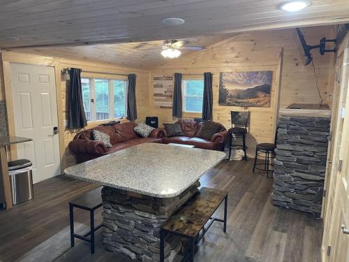 a living room with a stone fireplace in a cabin at Creekside 3 bedroom 2 bath cabin on private creek in Banner Elk