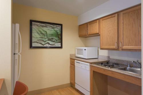 a small kitchen with a sink and a microwave at Homewood Suites by Hilton Newark-Wilmington South Area in Newark